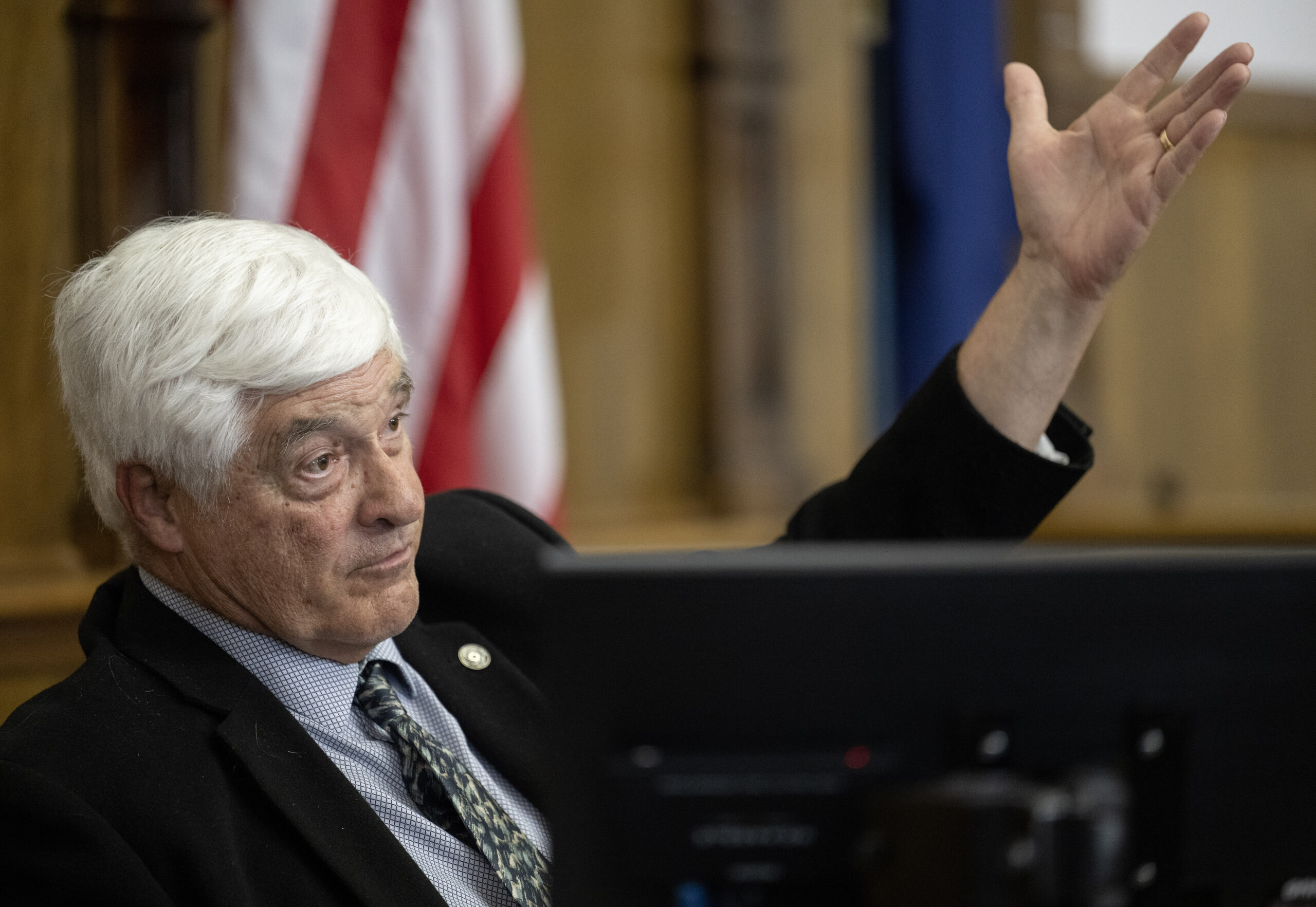 Steve in a juror booth facing right and gesturing upward